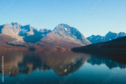 Beautiful vibrant summer view of Norwegian mountains and fjord reflection, Lyngen Alps, Finnmark county, northern Norway photo