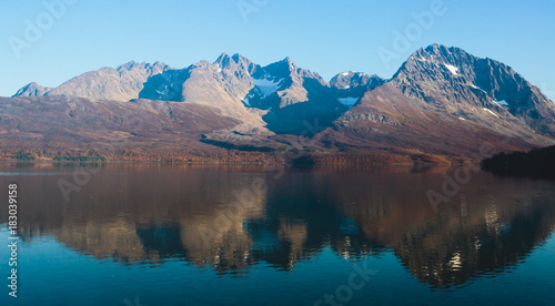 Beautiful vibrant summer view of Norwegian mountains and fjord reflection  Lyngen Alps  Finnmark county  northern Norway