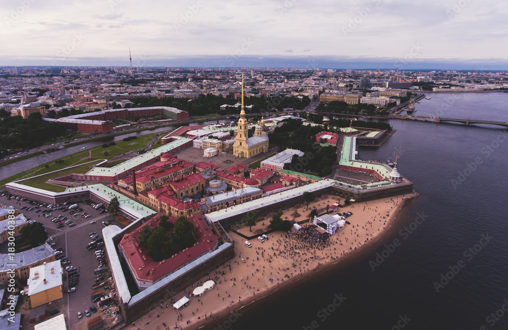 Fototapeta premium Beautiful aerial morning view of Saint-Petersburg, Russia, The Vasilievskiy Island at sunrise, Isaacs Cathedral, Admiralty, Palace Bridge, cityscape and scenery beyond the city, shot from drone