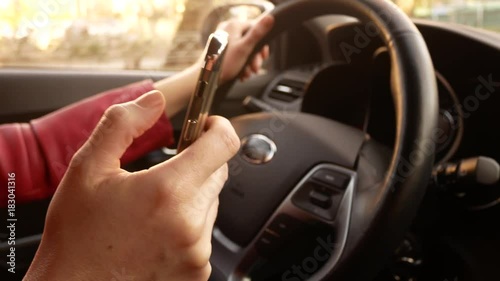 Woman texting while Driving. smartphone in the car. 4k