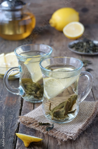 Hot green tea with lemon in glass mugs