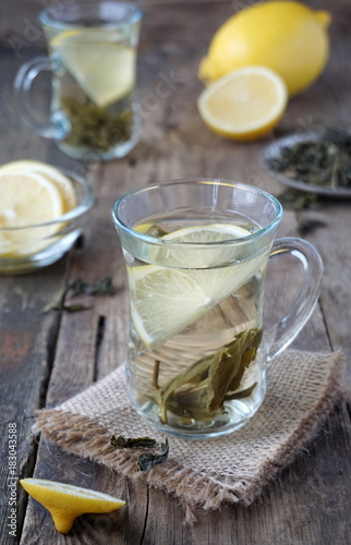 Hot green tea with lemon in glass mugs