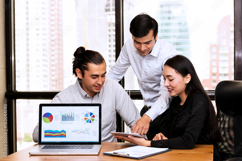 Future business leader concept. Group of young business team discussing work together in modern office with notebook screen in foreground. Future business leader concept. Group of young business team discussing work together in modern office with notebook screen in foreground.