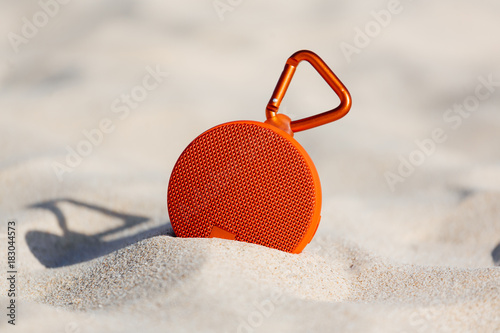 Portable wireless speaker on the beach