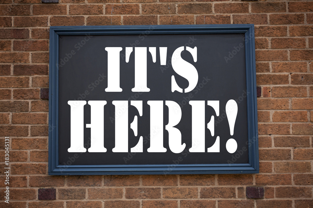 Obraz premium Conceptual hand writing text caption inspiration showing announcement It's Here. Business concept for advertisement written on frame old brick background with copy space