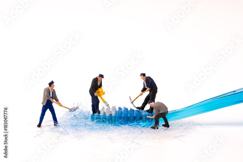 miniature figure people working with toothbrush
