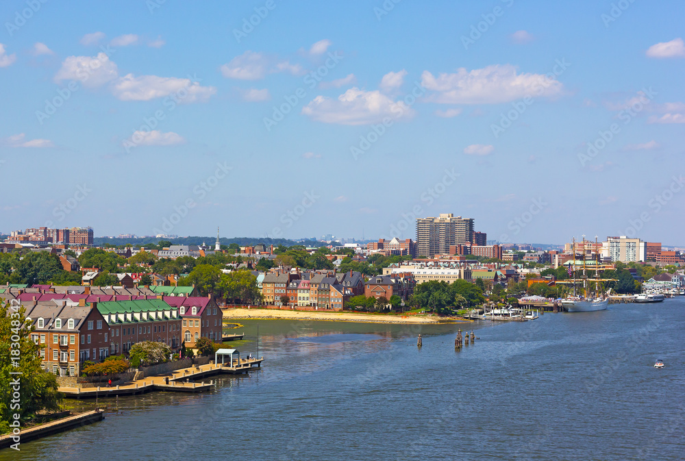 A view on old town Alexandria from the Woodrow Wilson Memorial Bridge, Virginia, USA. Potomac River panorama in early autumn.