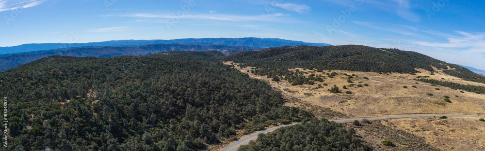 Single gray asphalt road in the California wilderness of the Los Padres National Forest.