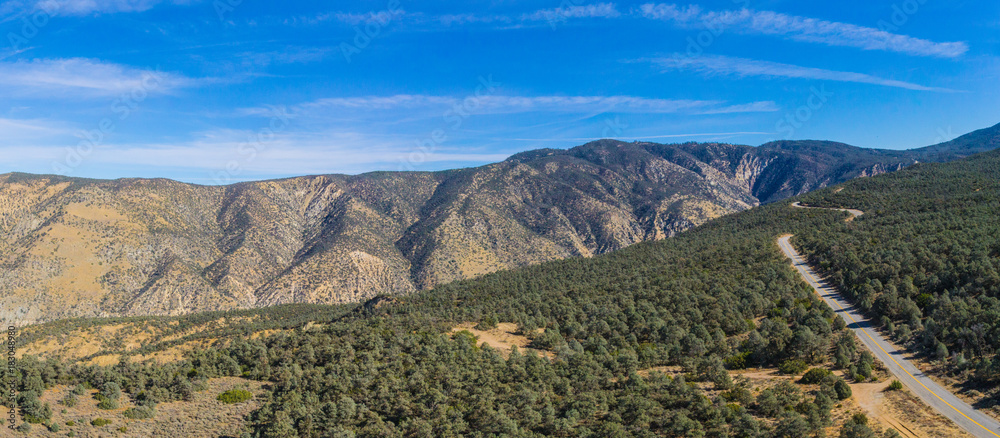 Naklejka premium Highway runs across a mountain ridgeline in the California wilderness.