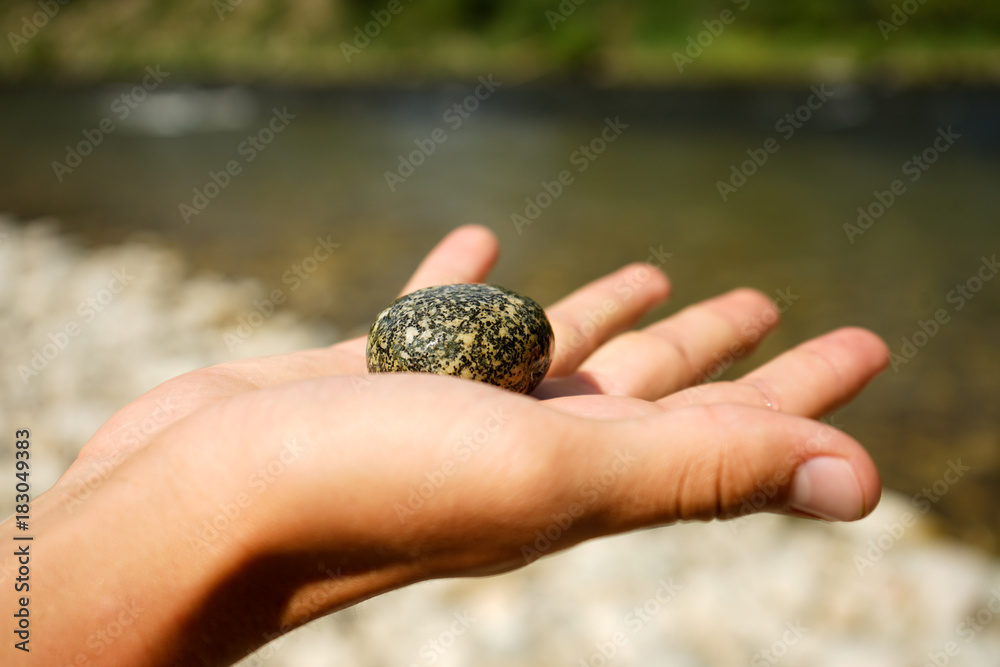 Close up of holding a river rock in hand Close up of holding a river rock in hand