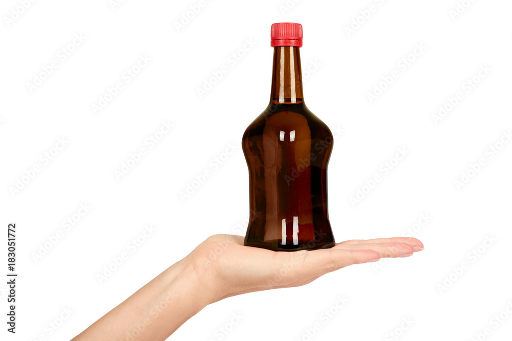 Glass bottle with soy sauce in hand isolated on white background. Asian food Glass bottle with soy sauce in hand isolated on white background. Asian food