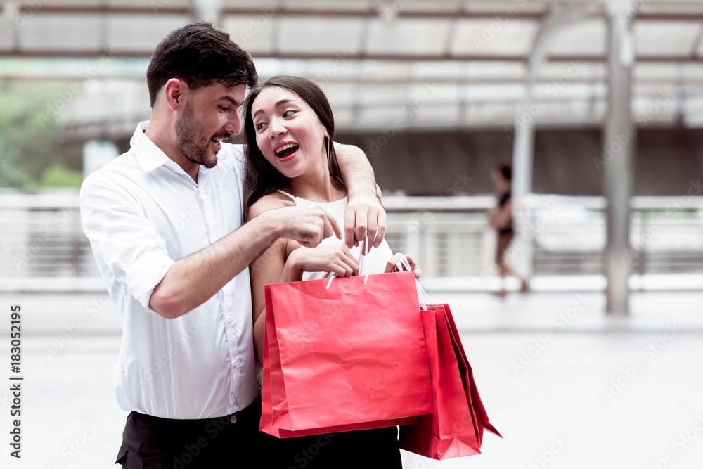 Happy couple cheering after a hard day of huge sale shopping in asian country. Happy couple cheering after a hard day of huge sale shopping in asian country.