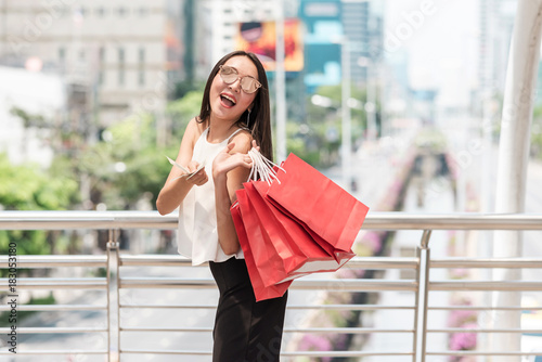 Modern single woman shopper in urban city concept.