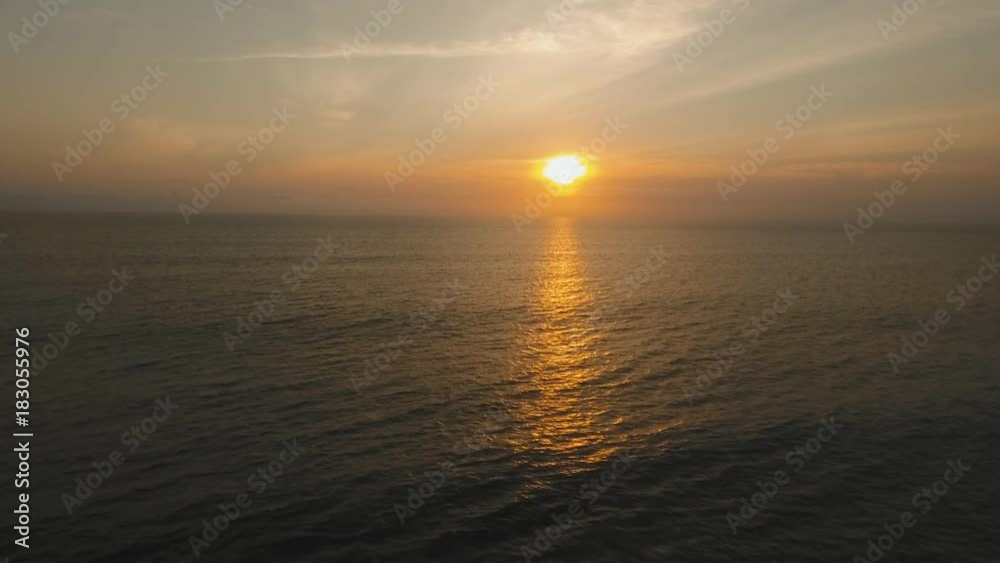 Aerial view orange sunset over the sea, the ocean. Flying over the blue ocean with blue water, sky. Bali,Indonesia.4K video. Travel concept. Aerial footage Aerial view orange sunset over the sea, the ocean. Flying over the blue ocean with blue water, sky. Bali,Indonesia.4K video. Travel concept. Aerial footage