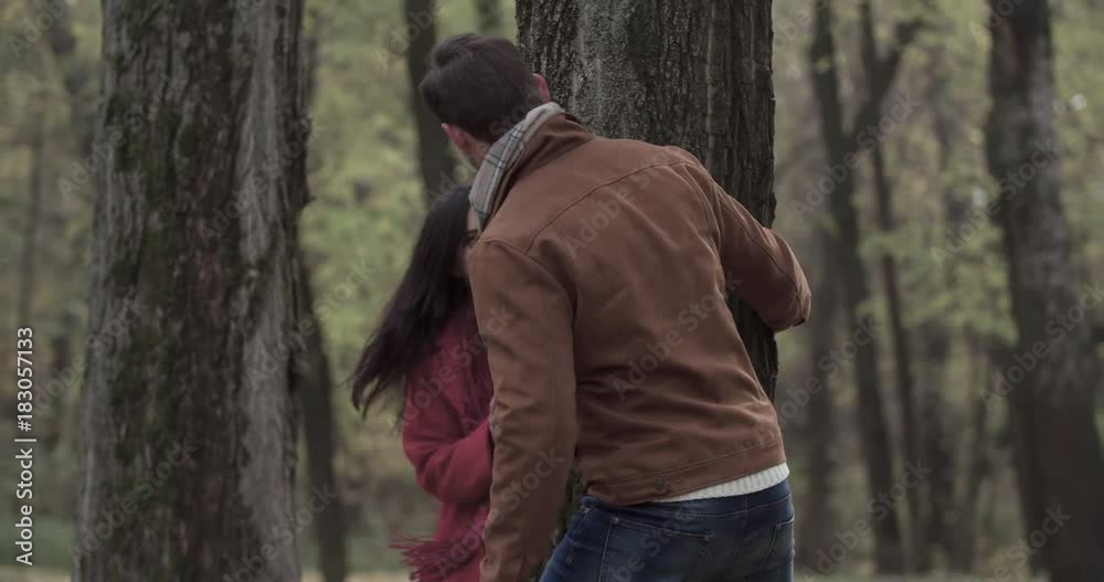 Loving couple walking in autumn forest park 4k video. Young man and overweight fat woman playing near tree romantic date. Love story romance concept