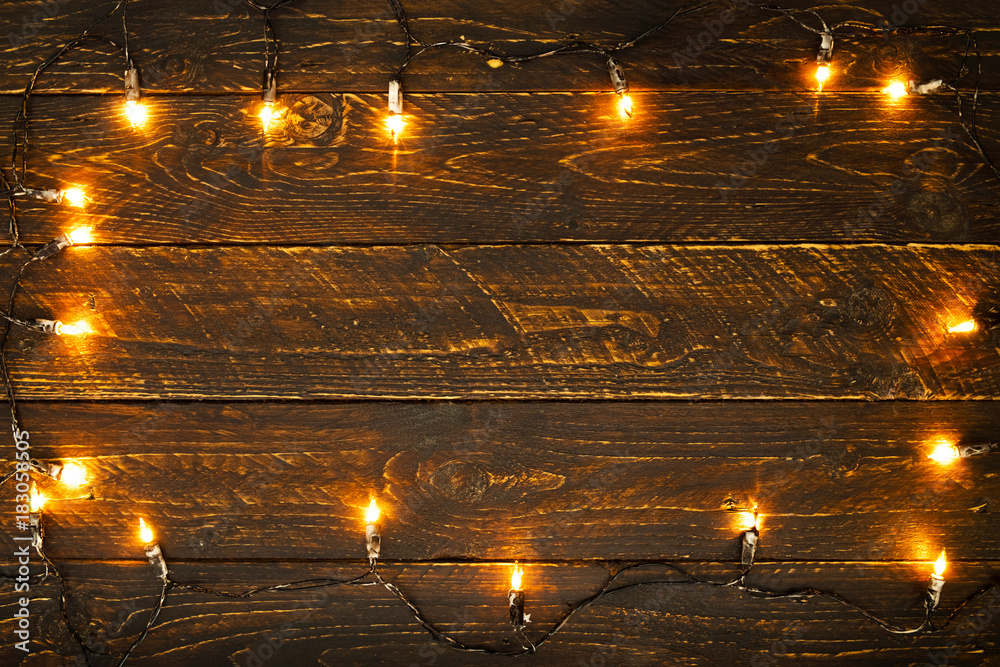 Christmas lights bulb on wood table. Merry christmas (xmas) background. topview, border design - rustic and vintage styles Christmas lights bulb on wood table. Merry christmas (xmas) background. topview, border design - rustic and vintage styles
