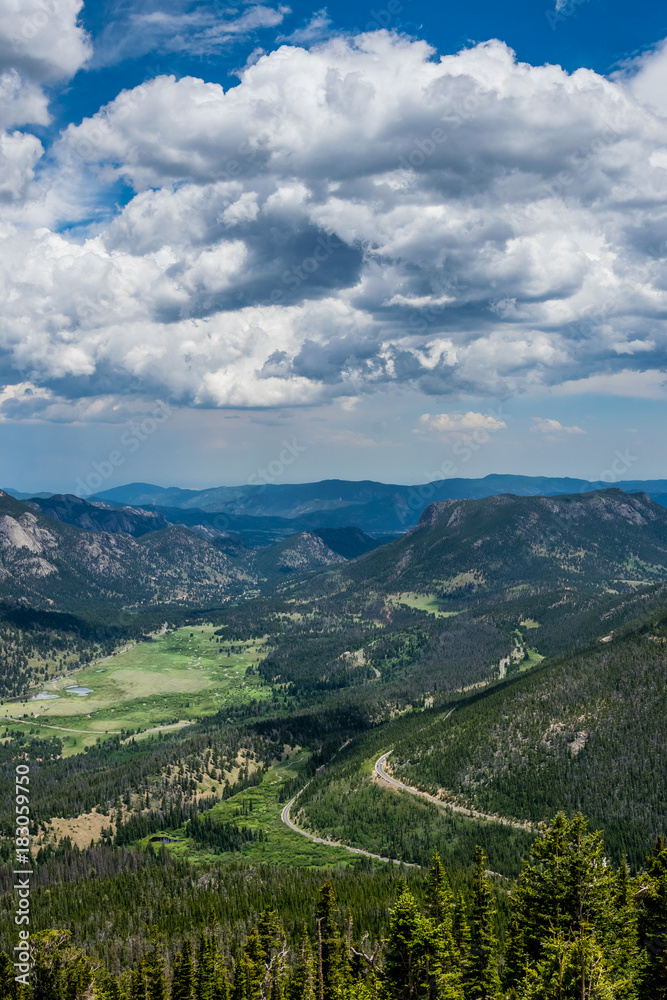 Green mountain valley and the winding mountain road. Summer in the Rocky Mountains