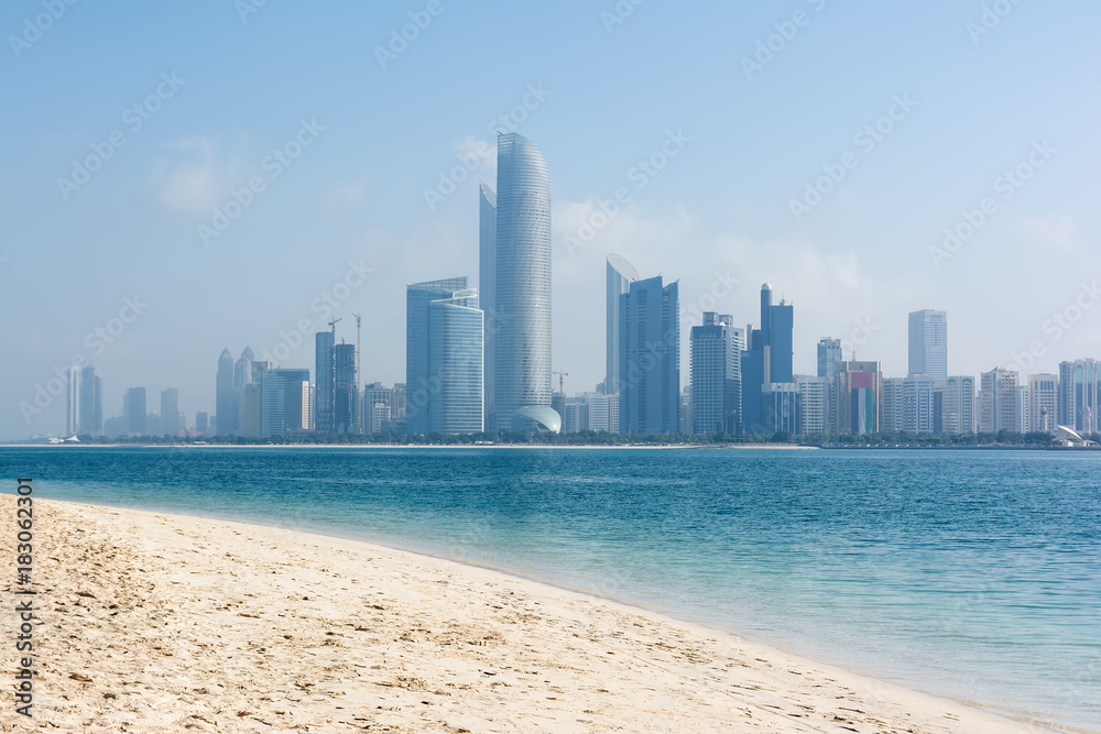 View to Abu Dhabi skyline from the beach, United Arab Emirates.