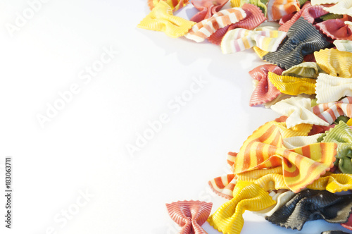 Beautiful colorful pasta in the shape of a butterfly isolated on white background. Striped pasta on a white background.