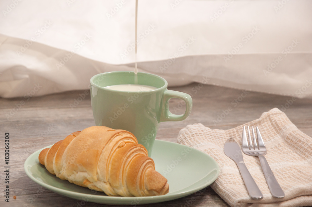 Croissant and cup of milk