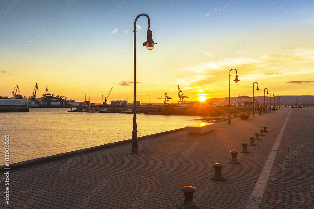 Streetlamps on the dock at sunset