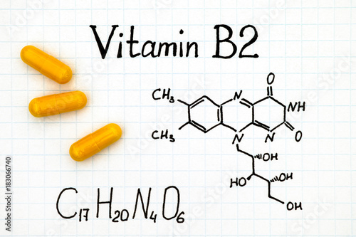 Chemical formula of Vitamin B2 and yellow pills.