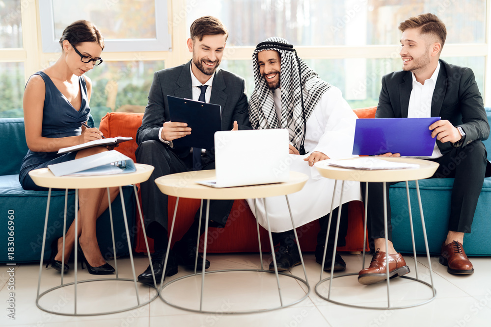 An arab businessman is discussing a business deal with his business partners. An arab businessman is discussing a business deal with his business partners.