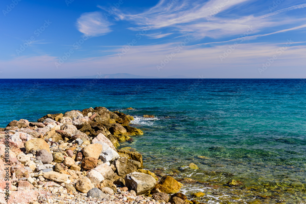 A beautiful pebbly beach in the village of Karlovasi, Samos island, Greece A beautiful pebbly beach in the village of Karlovasi, Samos island, Greece