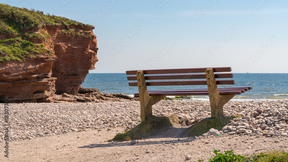 Bench and pebble beach, Otterton Ledge looking towards Lyme Bay, Budleigh Salterton, Jurassic Coast, Devon, UK