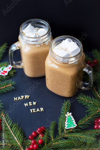 marshmellou cocoa, Christmas tree with decorations on a black background. The inscription Happy New Year photo