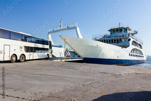Vehicle, bus is entering to ferryboat's deck, boarding cargo