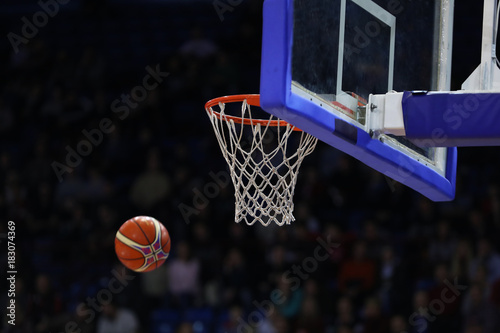 Basketball ball, board and net on black background sports hall © makedonski2015