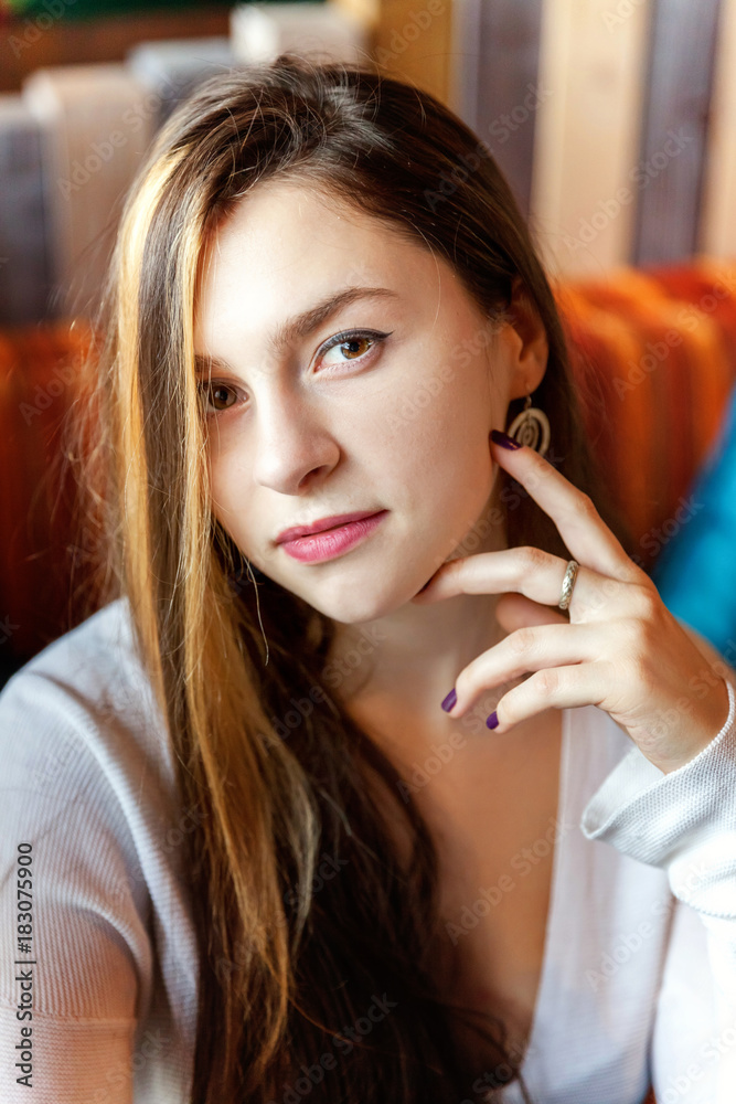 Beautiful young brunette girl sitting in cafe. Woman in restaurant Beautiful young brunette girl sitting in cafe. Woman in restaurant