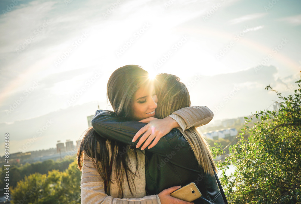 Φωτογραφία Happy meeting of two friends hugging at sunset outdoor - Pleasant moment of youn
