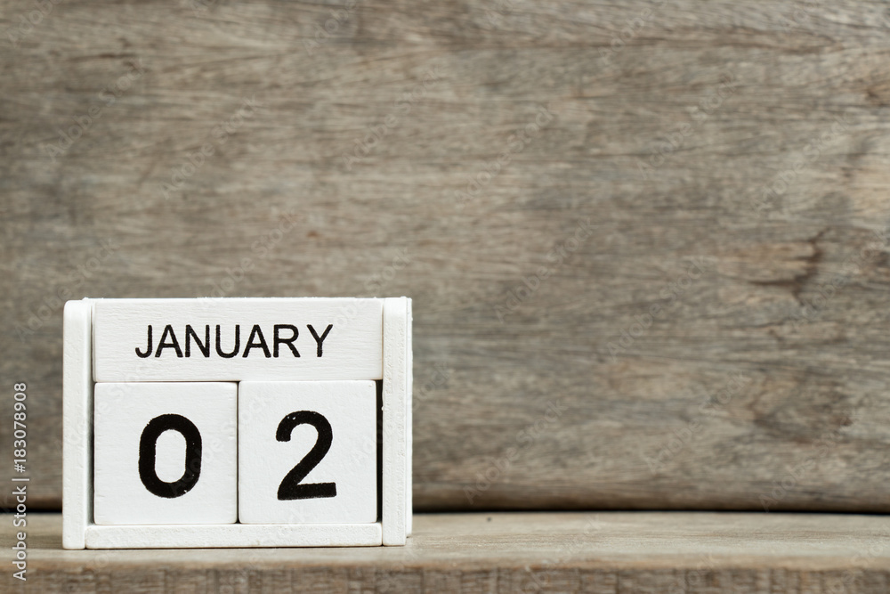 White block calendar present date 2 and month January on wood background White block calendar present date 2 and month January on wood background