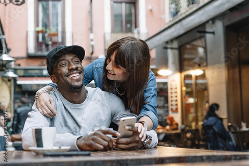 Young man and woman using telephone