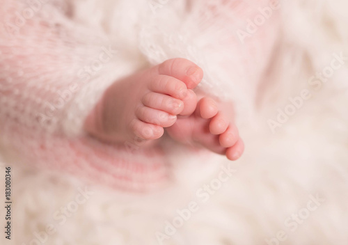 Tiny little toes of infant sleeping wrapped up in blanket