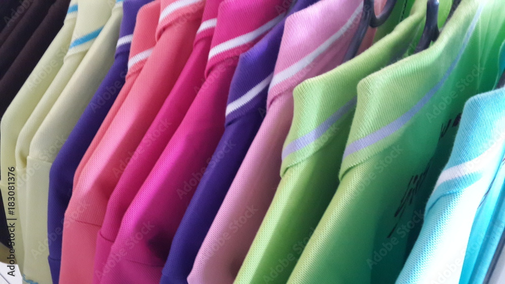 Colorful t-shirts on hangers