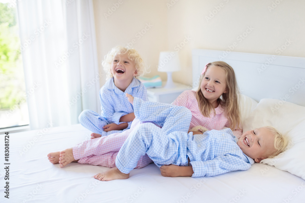 Kids in bed. Children in pajamas. Family bedroom. Kids in bed. Children in pajamas. Family bedroom.