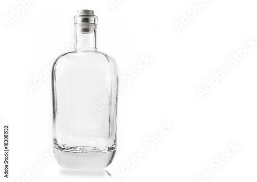 Empty glass bottle with cork on the white background