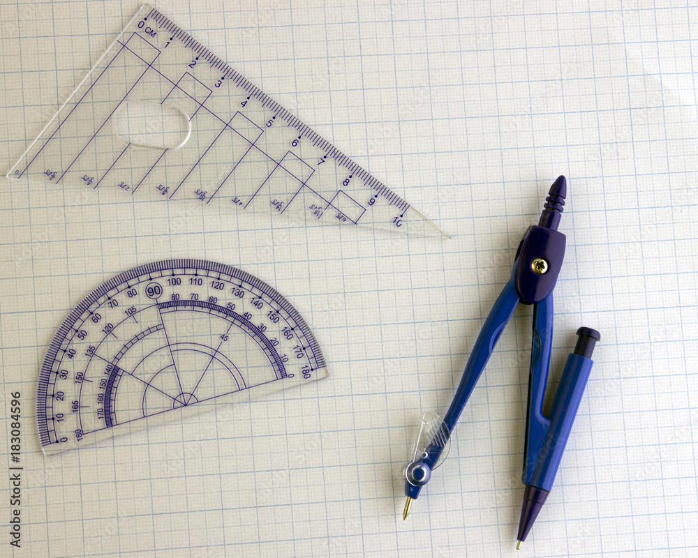 The compass ruler and protractor on the graph paper Stock Photo Adobe