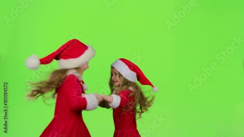 Children in red New Year costumes are dancing. Green screen. Slow motion photo