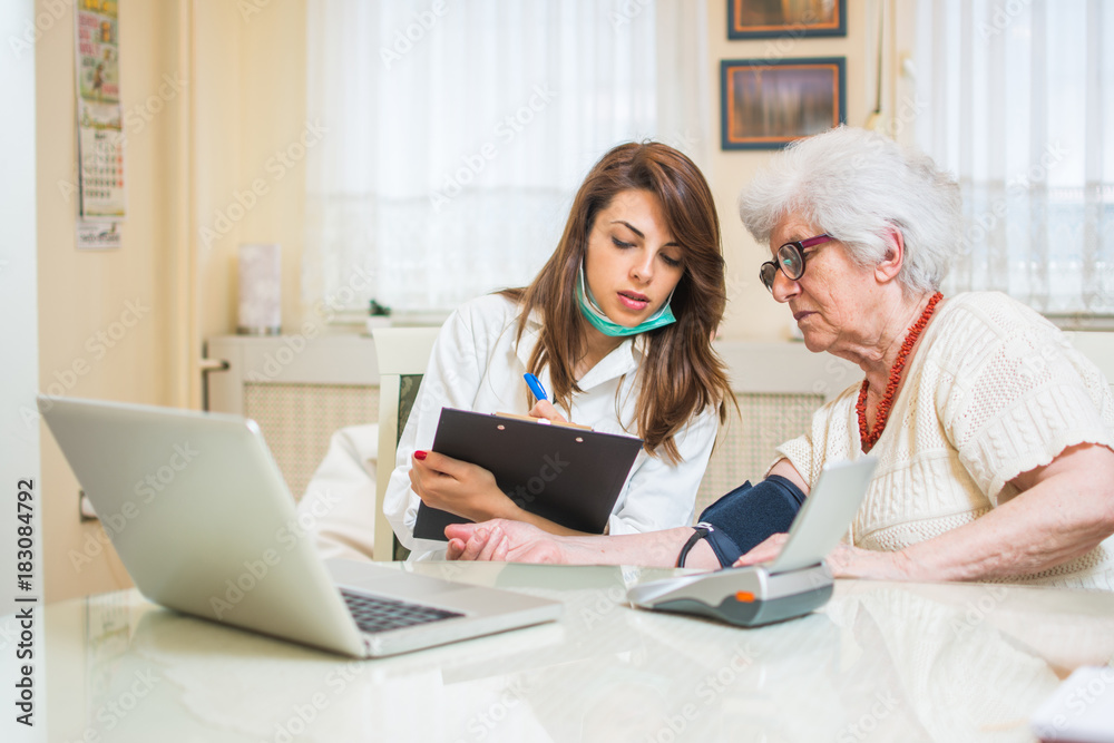 Nurse measuring blood pressure of senior woman. Nurse measuring blood pressure of senior woman.