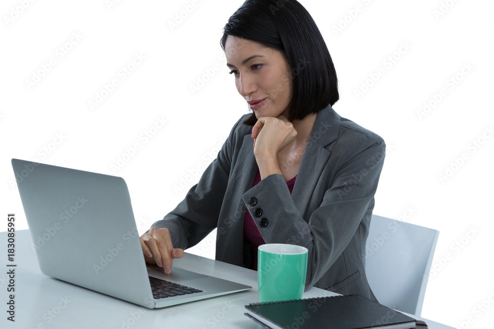 Businesswoman using laptop at desk Businesswoman using laptop at desk