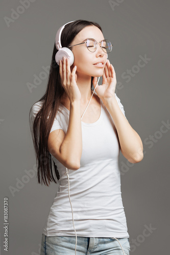 Delighted young woman listening to music