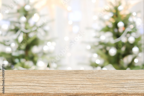abstract blurry beautiful of decoration Christmas tree background with plank wooden texture floor for show advertise promote product concept