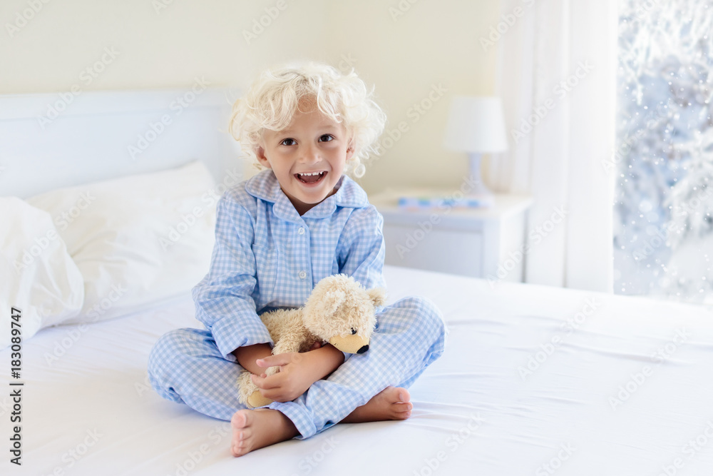Kid in bed. Winter window. Child at home by snow. Kid in bed. Winter window. Child at home by snow.