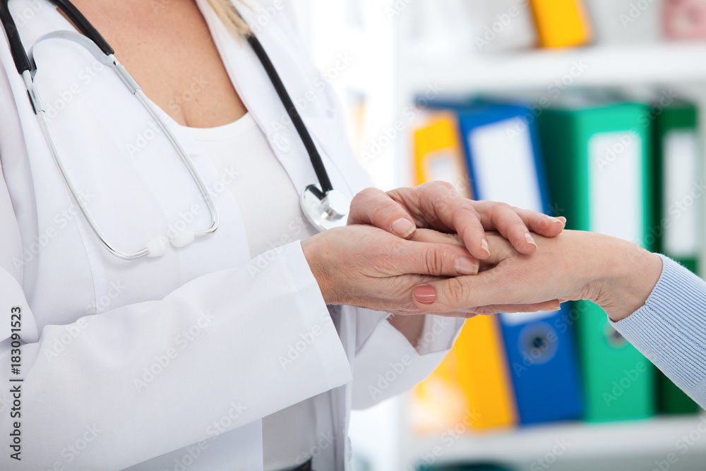 Hand of doctor reassuring her female patient. Medical ethics and trust concept. Handshake, hands closeup Hand of doctor reassuring her female patient. Medical ethics and trust concept. Handshake, hands closeup