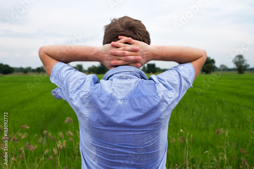Foto Man with hyperhidrosis sweating very badly under armpit in blue shirt, isolated