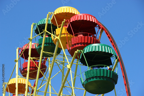 Retro colored Ferris Wheel on Blue Sky.